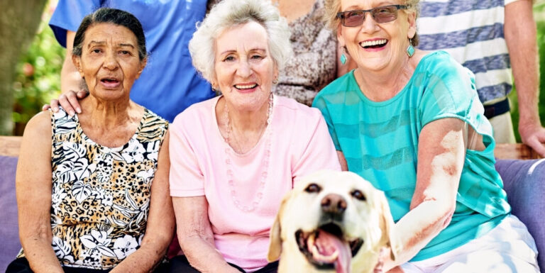 Seniors with Dog Enjoying Community Event at Independent Living Facility