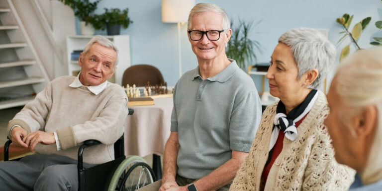 Group of Elderly Residents Socializing Together Indoors at an Independent Living Facility